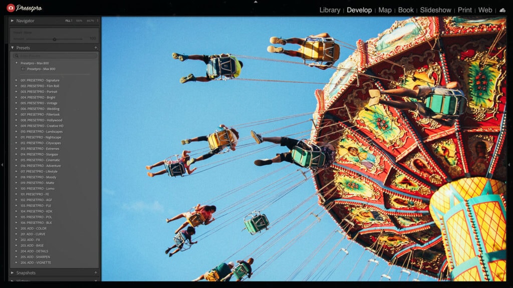 Screenshot of Adobe Lightroom Classic featuring a vibrant carnival swing ride with colorful chairs and ornate decorations. The image uses the Kodak Max 800-inspired Lightroom preset from Presetpro, highlighting saturated colors and fine film grain.