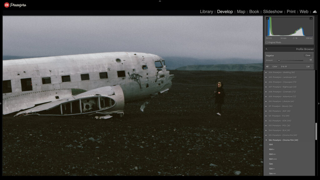 Abandoned airplane on a dark landscape with a person standing nearby, Nordic film emulation style.