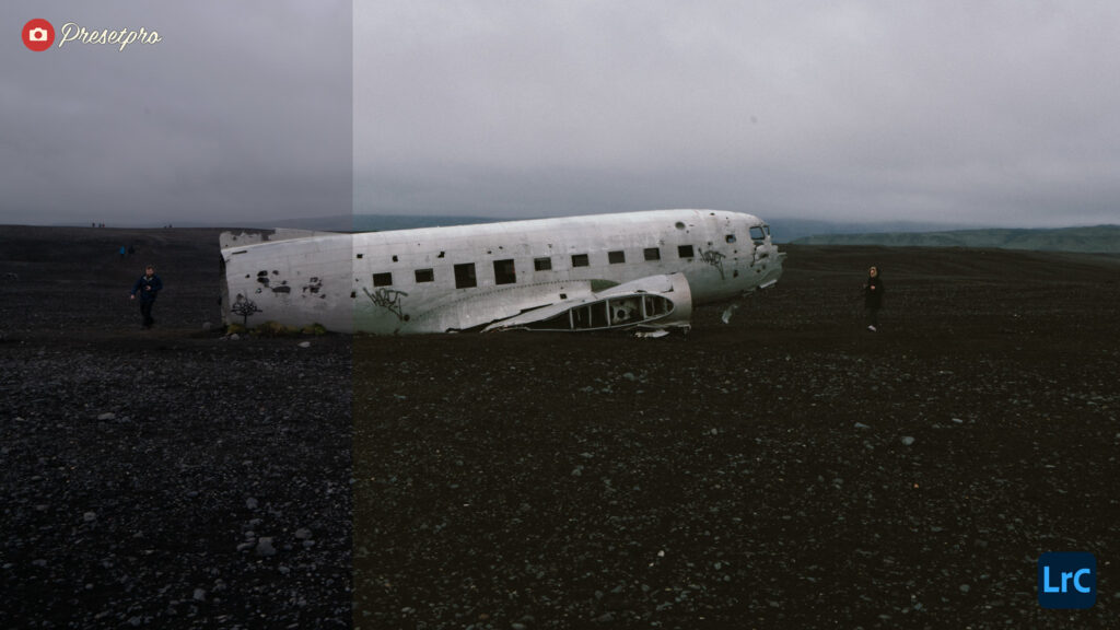 Derelict airplane wreck on dark volcanic terrain in Iceland under cloudy sky.