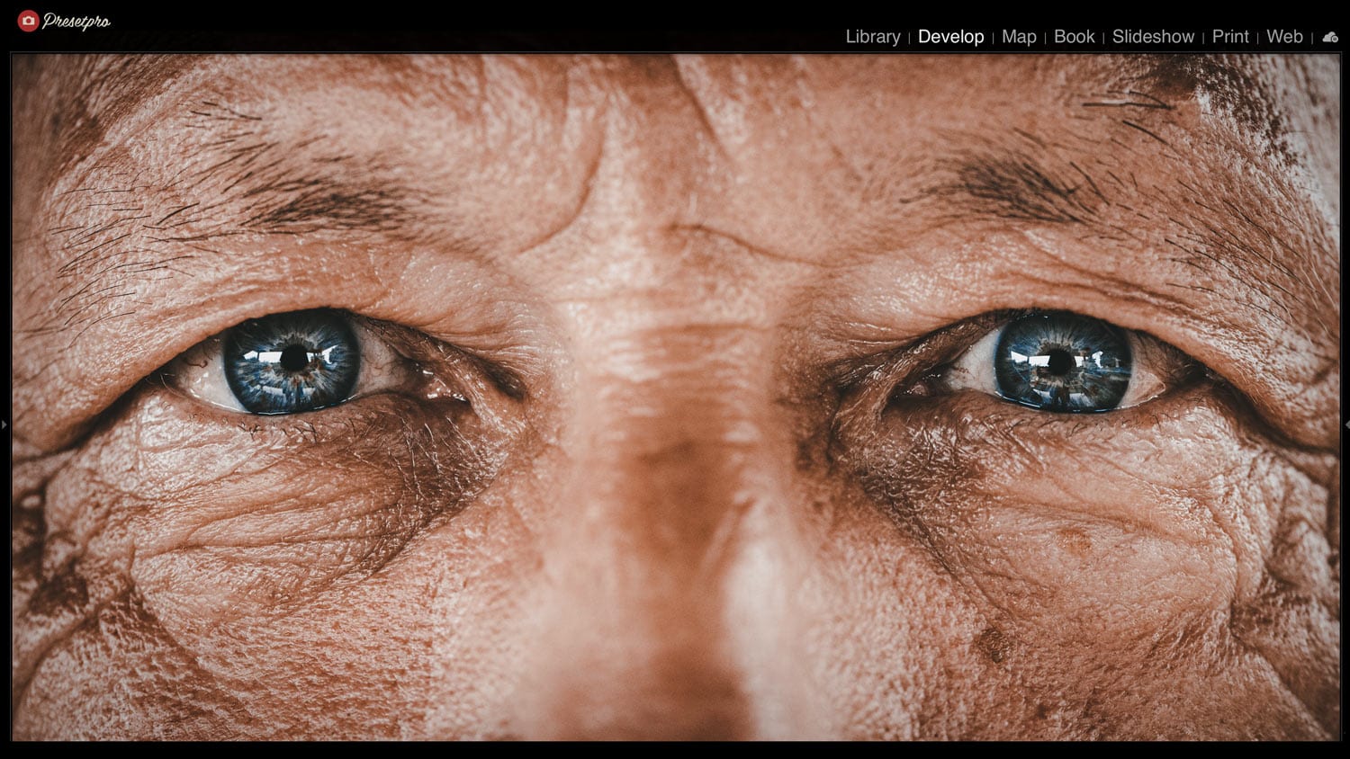 Close-up of aged man's eyes with vintage film effect, inspired by analog film styles.
