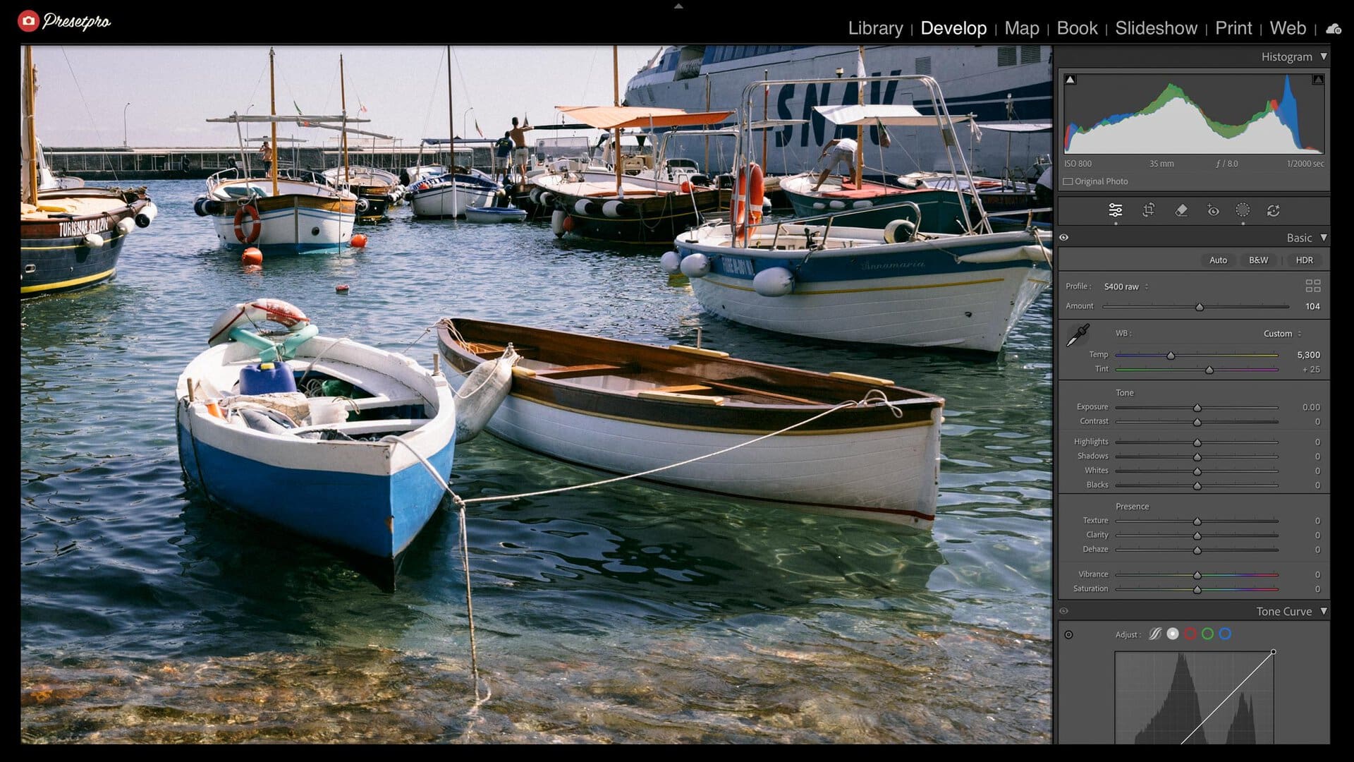 Lightroom Classic Develop panel with the S400 raw profile at Amount 104 on wooden boats in the clear water of a harbor on Capri, every tone slider at zero